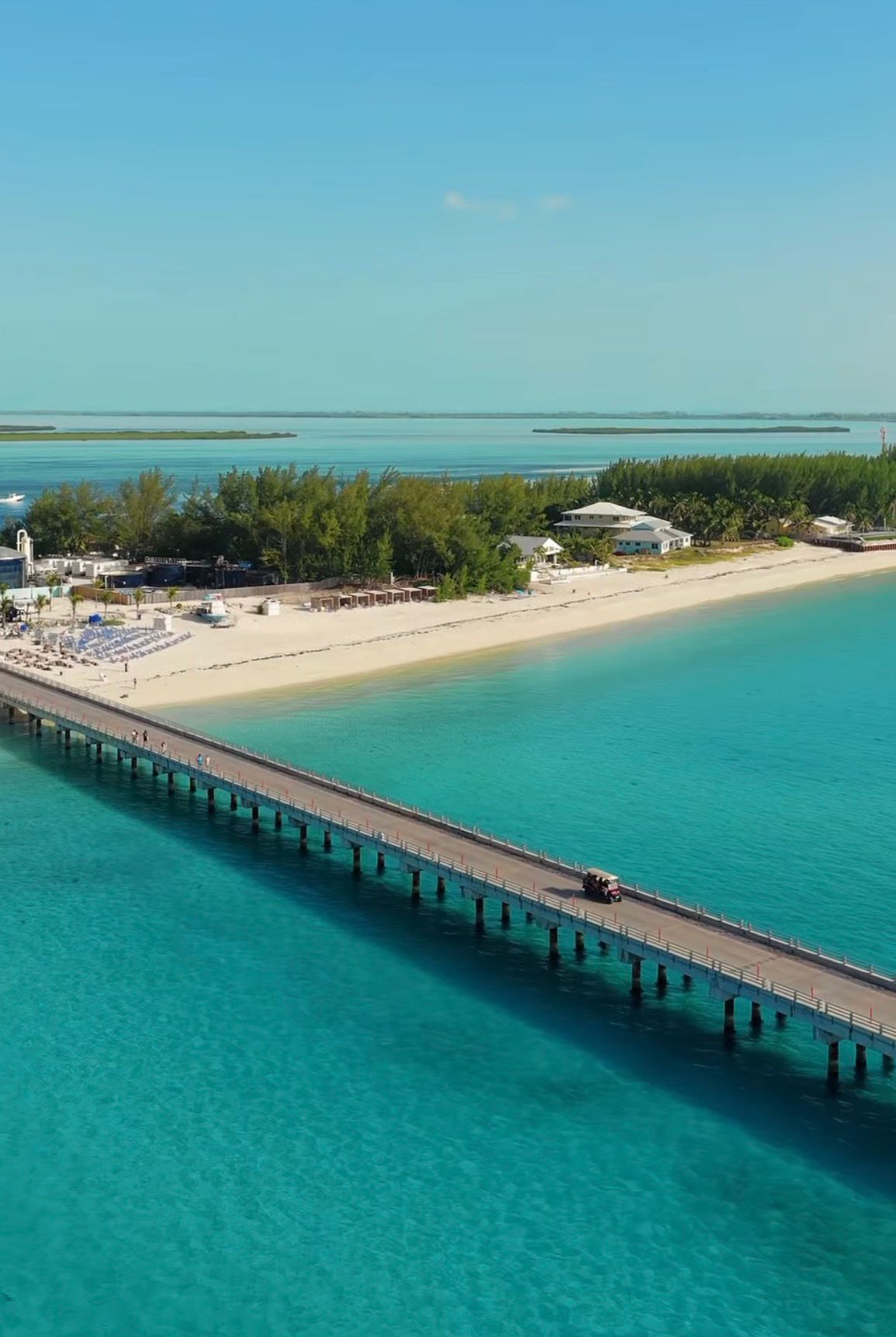 Long pier stretching from a white-sand Bimini beach