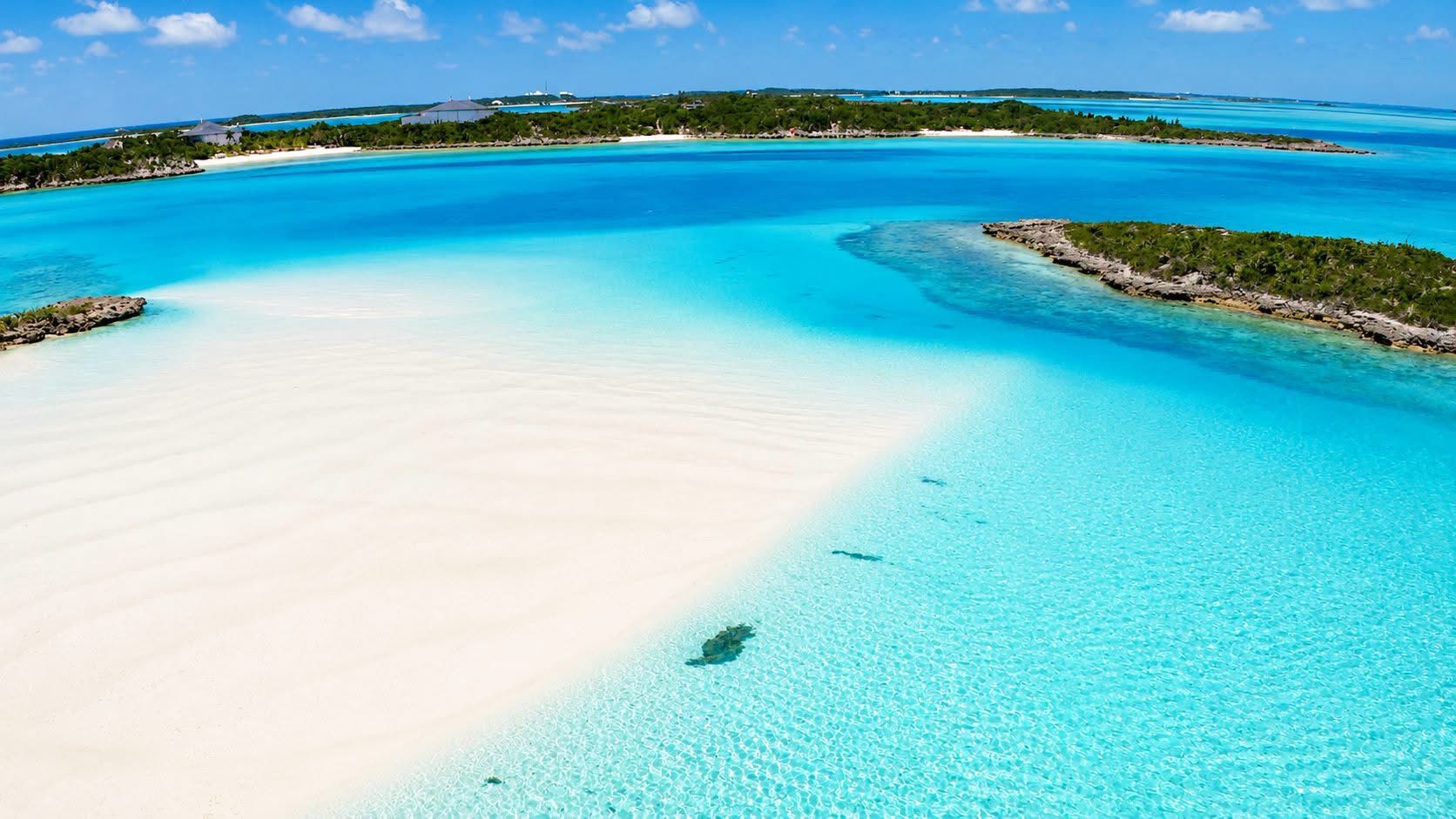Aerial of white sandbars and turquoise channels around Bimini cays